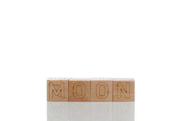 Naklejka premium Wooden cubes with letters moon on a white background