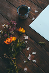 Flowers, coffee and paper on the table