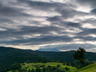 Summer in Spisz in Poland and Slovakia with view to Tatra Mountains. Dramatic sky.