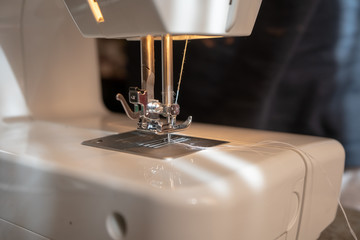 The sewing machine and cotton fabric close up