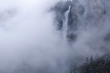 Fotobehang Winter landscape of Upper Yosemite Falls in fog captured with motion blur, Yosemite National Park, California, USA © Dean Pennala