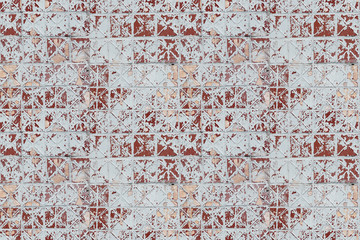 seamless texture of old tiles with peeling ocher paint
