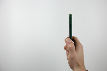 Phone in hand on a white background with black screen. For presentation application.