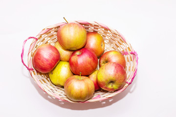 apples in a basket on a white background close up