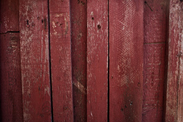 Red wooden fence with vertically arranged bars