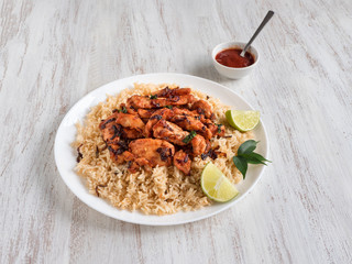 Homemade chicken Biryani. Arabic traditional food bowls Kabsa with meat