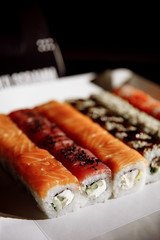 Sushi, Asian food, rolls, Philadelphia, sesame. Restaurant food. Fast food. Sushi set, set lunch. On a black background.