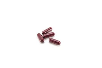 red oval capsules on a white isolated background,several capsules on a white isolated background