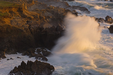 Landscape at sunset of crashing wave captured with motion blur, Pacific Ocean, Northern California, USA