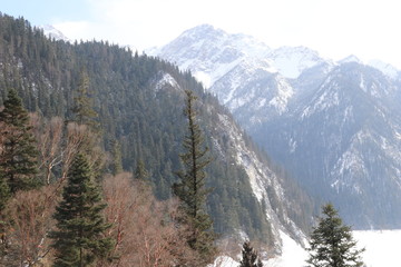  Frozen lake surrounded by snow covered mountains
