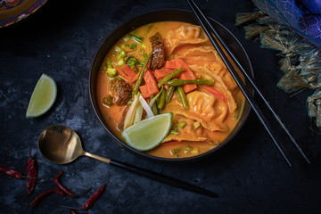 Red thai curry and wonton soup with vegetables