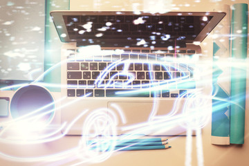 Auto pilot hologram drawing over computer on the desktop background. Top view. Double exposure. Tech concept.