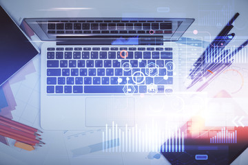 Multi exposure of data drawing hologram over topview of study desk background with computer. Concept of technology.