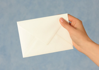 Hand with white envelope