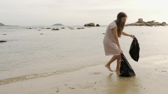 Mom and baby collect garbage from the coast
