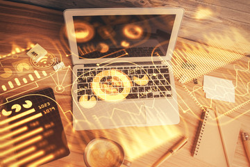 Technology hologram drawing over computer on the desktop background. Top view. Double exposure. Tech concept.