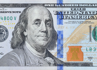 Portrait of US president Benjamin Franklin on 100 dollars banknote closeup macro fragment. United...