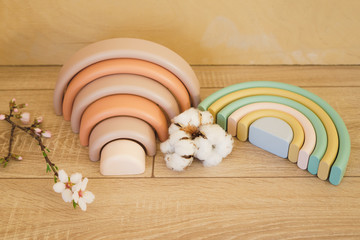 Two multi-colored wooden rainbows.