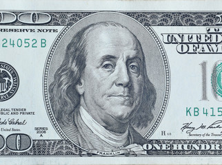 Portrait of US president Benjamin Franklin on 100 dollars banknote closeup macro fragment. United...