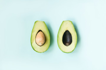 2 halves of avocado lie on a background top view