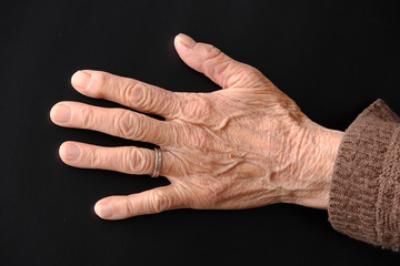 Fototapeta na wymiar Covidien-19 virus and an elderly human hand,