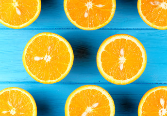 Fresh half cut oranges on wooden blue table