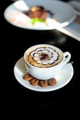 cup of coffee with latte art on top with cookies. morning coffee 