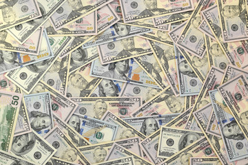 Many one hundred and fifty dollar bills on flat background surface close up. Flat lay top view