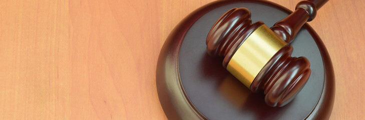 Justice mallet on wooden desk in a courtroom during a judicial trial. Law concept and empty space...