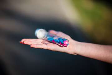 Protection. Tablets. Vaccine. Coronavirus. Hand in gloves holding pills. Vitamins. Salvation. Age. The glove.