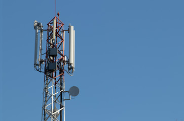 Telecommunication tower with blue sky in the background.