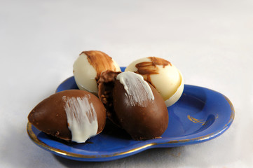 Chocolate eggs, handmade, gluten free. Selective focus. White background. Close view. Horizontal....