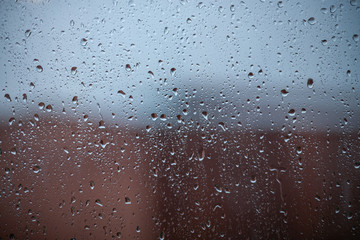 Nasty rainy days, raindrops on window, abstract background in bokeh