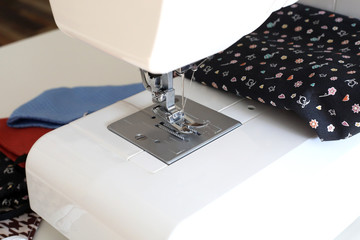 Sewing machine to sew the face medical mask to protect against the coronavirus pandemia. Home made...