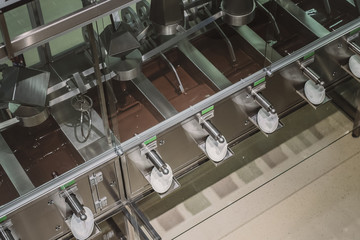 Industrial stirring of chocolate. Machines in chocolate factory stir the chocolate mixture in stainless steel containers.