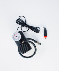 Car pump with manometer, air compressor on white background.