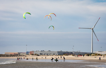Kitesurfers enjoying a beautiful day at the beach