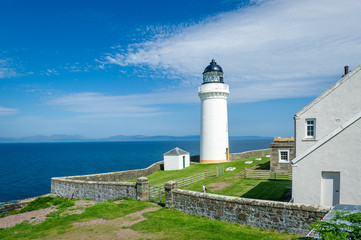 Davaar island white lighthouse and cottadges. Campbeltown, Scotland
