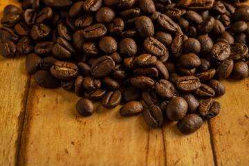 Detail of Veracruz bean coffee, grown in Veracruz, Mexico. On a wooden planks table...