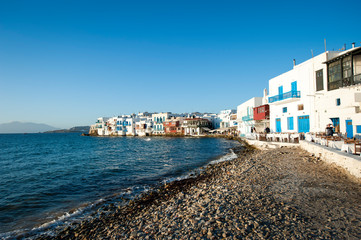Bright scenic afternoon view of the colorful waterfront promenade of Mykonos Town, Greece