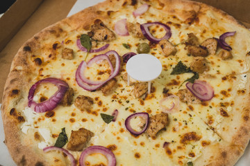 Pizza saver or ottoman, known also as pizza table, used in pizza deliveries to save the pizza being squished in a cardboard box. Tasty delicious pizza being saved by pizza saver.
