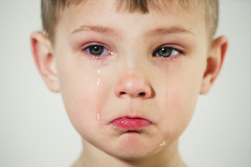 little boy with tears on his face close-up