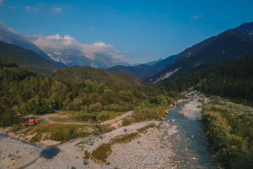 Wild camping in italian Julian alps in the valley of Resia. Evening view of Resia river with...