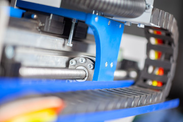 cable guides of the cnc machine in black. In the background the ball screw carriage