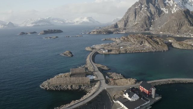 aerial video of typical lofoten drying racks with cod fish.winter/spring is the main season for fishing in lofoten. hanging fish in the racks drying by fresh wind.spring atmosphere with mountains