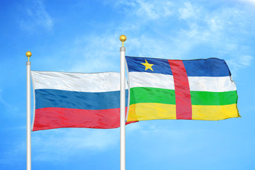 Russia and Central African Republic  two flags on flagpoles and blue cloudy sky