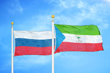 Russia and Equatorial Guinea two flags on flagpoles and blue cloudy sky