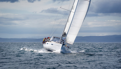 New sailing yacht going fast and beautiful directly on the camera. Sailing regatta in Scotland...