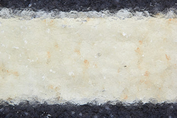 sleet texture hidden under a layer of wet snow markings on the asphalt selective focus