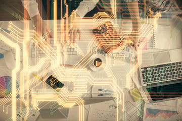 Double exposure of man and woman working together and technology theme drawing. Computer background. Top View. High tech concept.